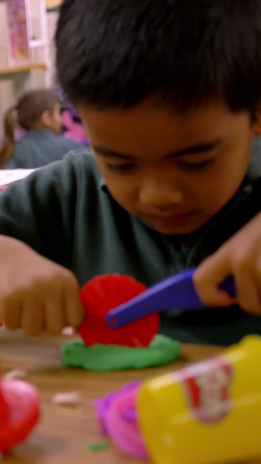 A child exploring playdough in an Inspire classroom